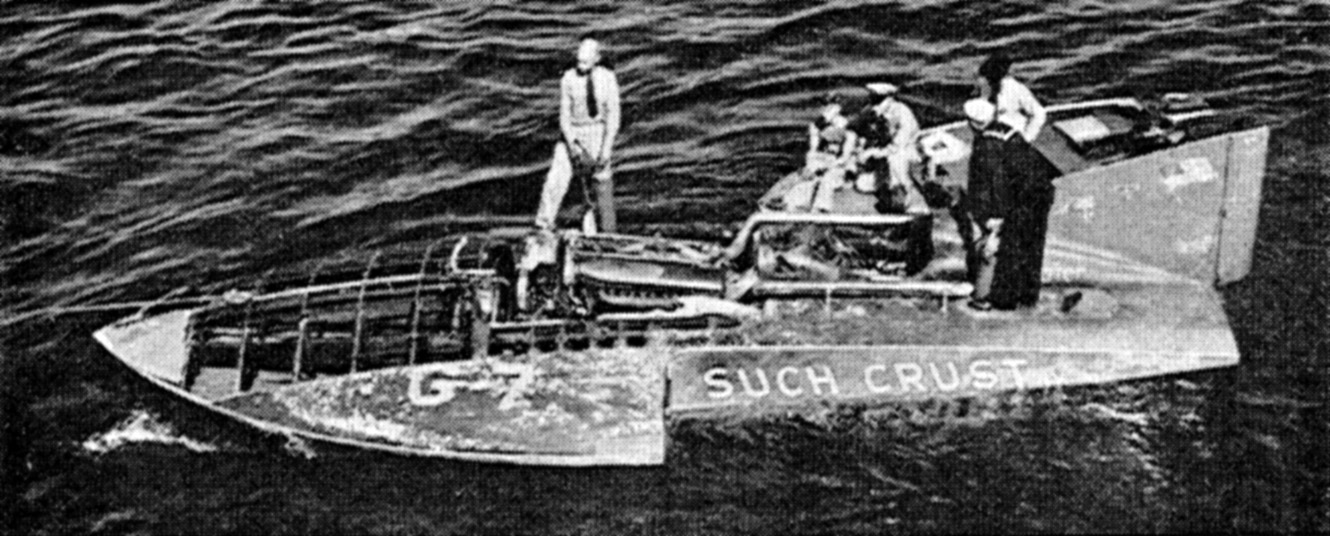 Such Crust IV, tended by Coast Guardsmen, is towed back to the pits